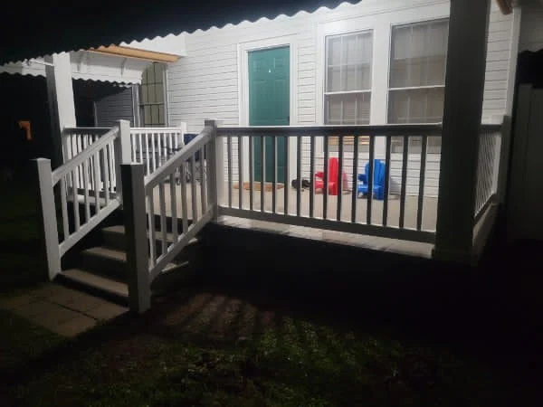 Aluminum handrail running down a set of exterior steps