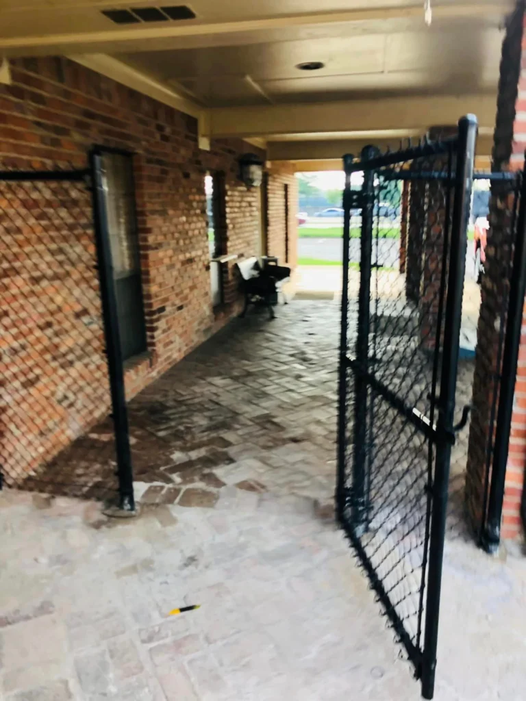 Black metal gate securing a covered entry