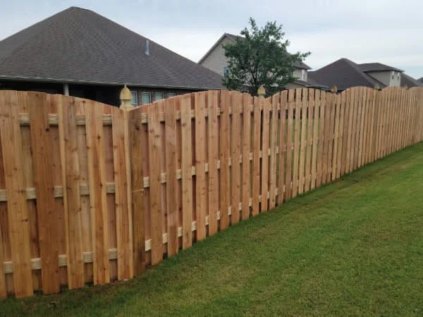 196 feet of 6 foot board to board arch top wood fence with decorative post caps
