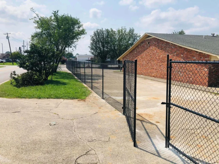 Chain link fence and gate beside a brick building