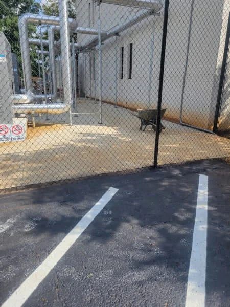 310 feet of 10 foot commercial black vinyl chain link fence enclosing plant equipment