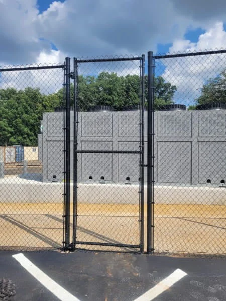 10 foot commercial black vinyl coated chain link fence at an industrial site