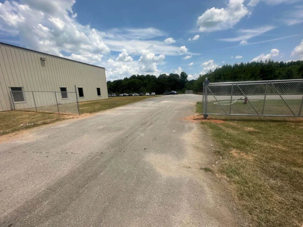 Chain link perimeter fence around a commercial parking lot