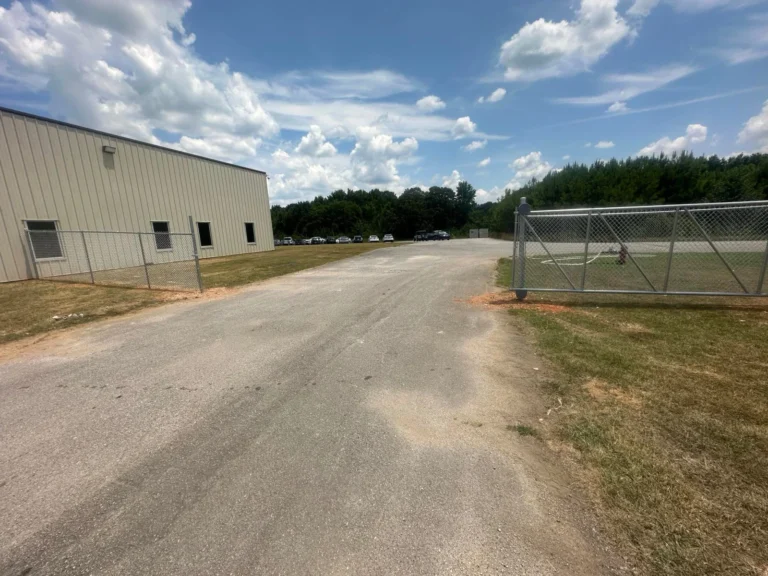 Chain link perimeter fence around a commercial parking lot