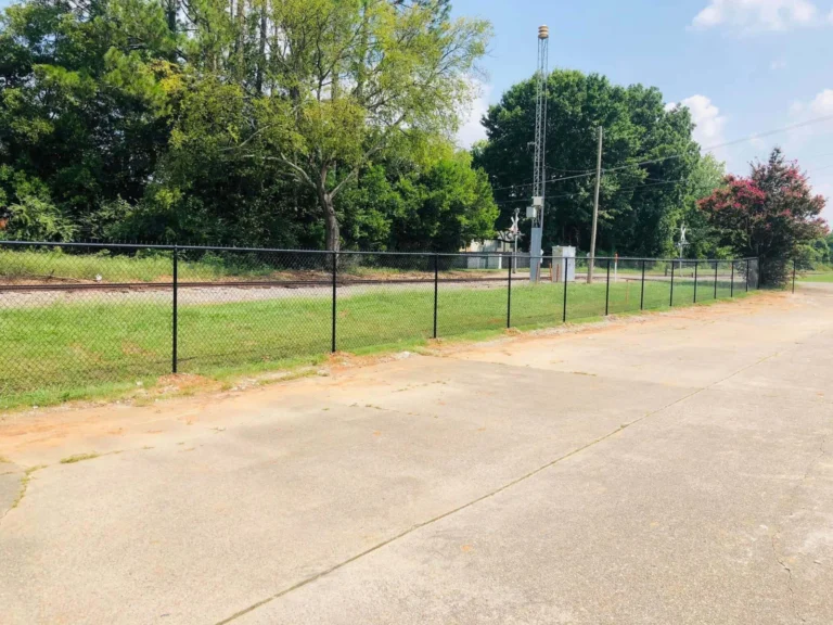 Rail fence running alongside a residential driveway