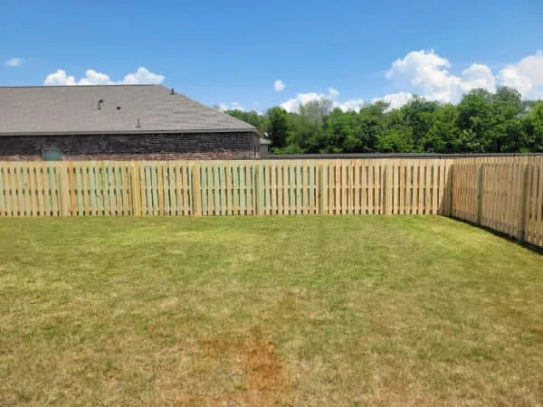 Shadowbox wood fence enclosing a residential back yard