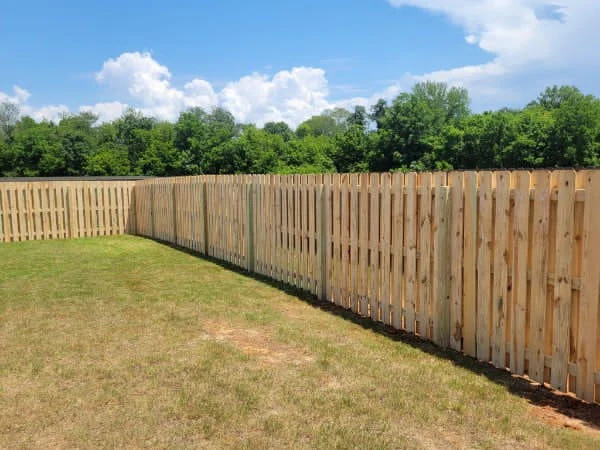 Shadowbox fence boards alternating on both sides of the rail