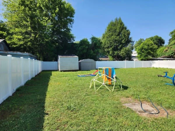 White vinyl privacy fence panels with a flat top rail