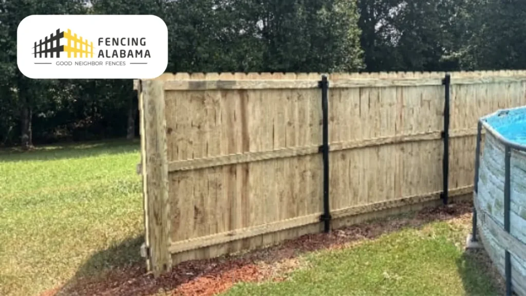 Wood fence panels attached to galvanized metal line posts