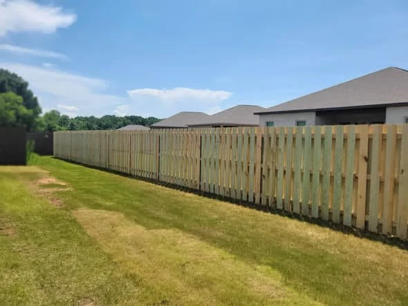 Long run of wood privacy fence across a back yard